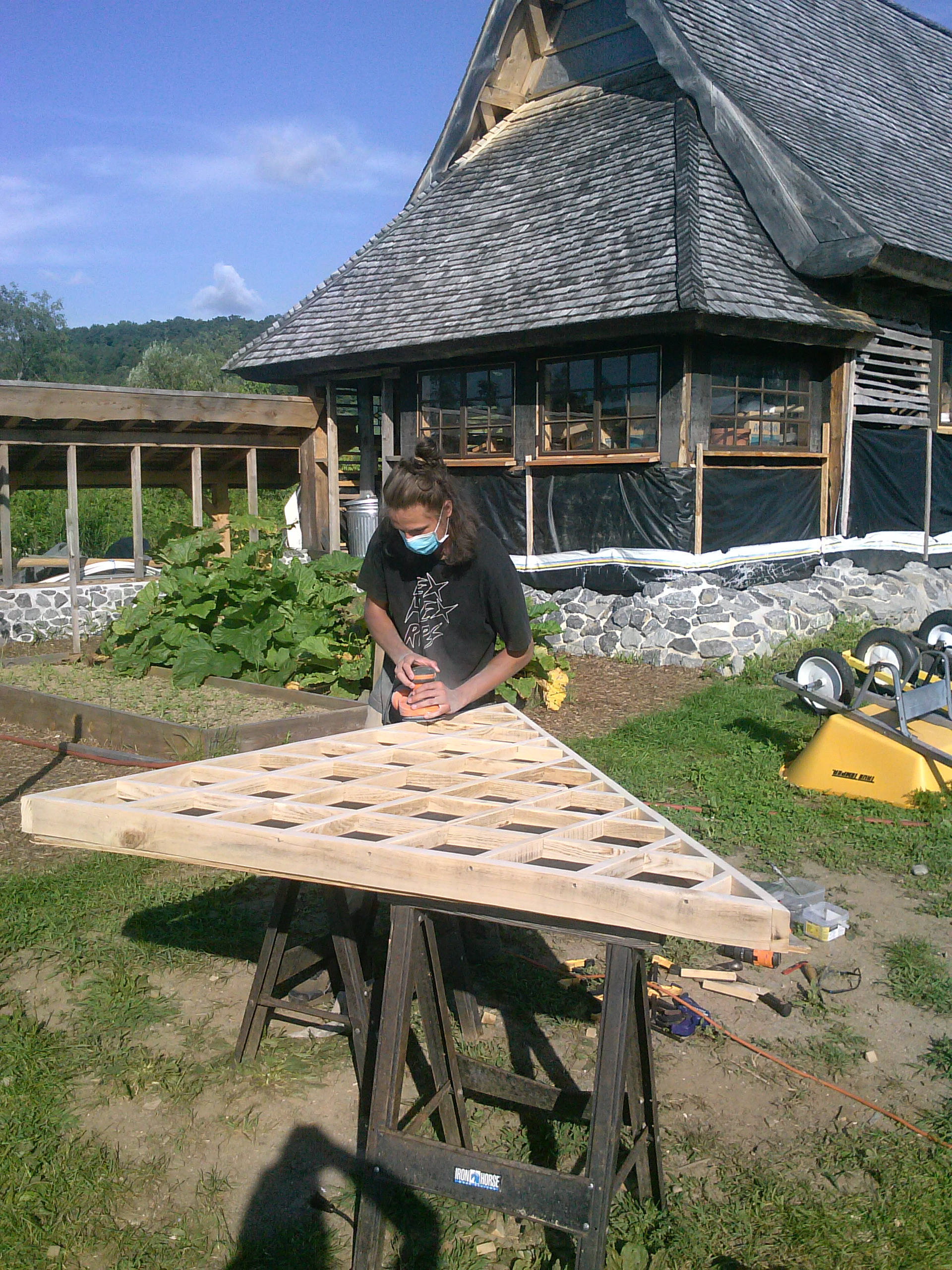 Intern sanding a wooden window frame